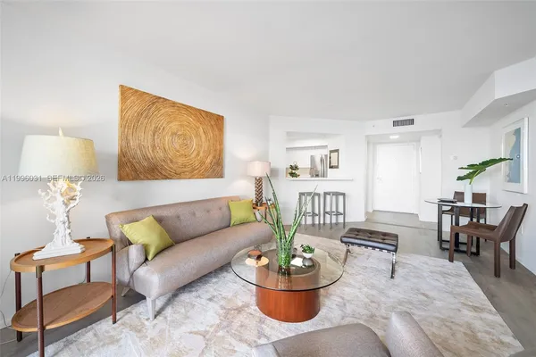 a living room with furniture and a potted plant