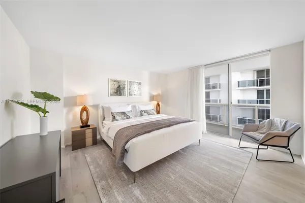 a bedroom with a bed a table and chair