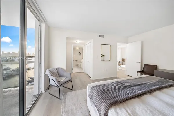 a bedroom with a bed and a mirror