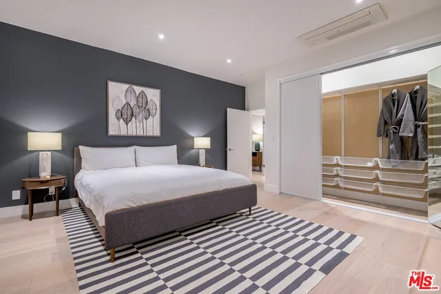 a bedroom with a bed and a walk in closet