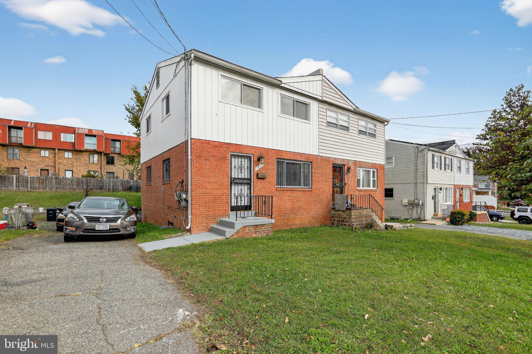 a front view of a building with a yard