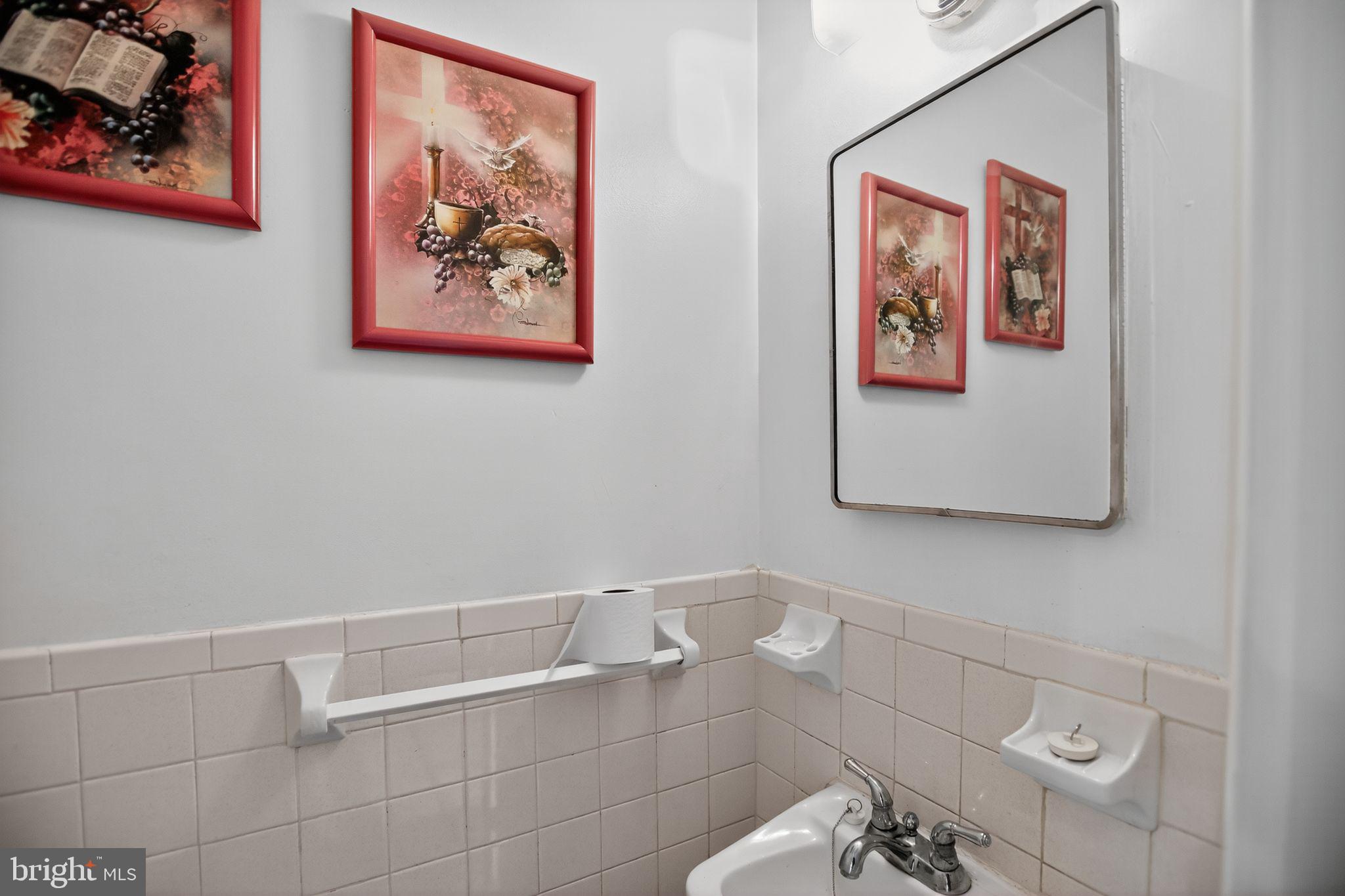 1432 41st Street Southeast Washington, DC 20020 - Photo 21 of 29 a bathroom with a toilet and a picture on the wall