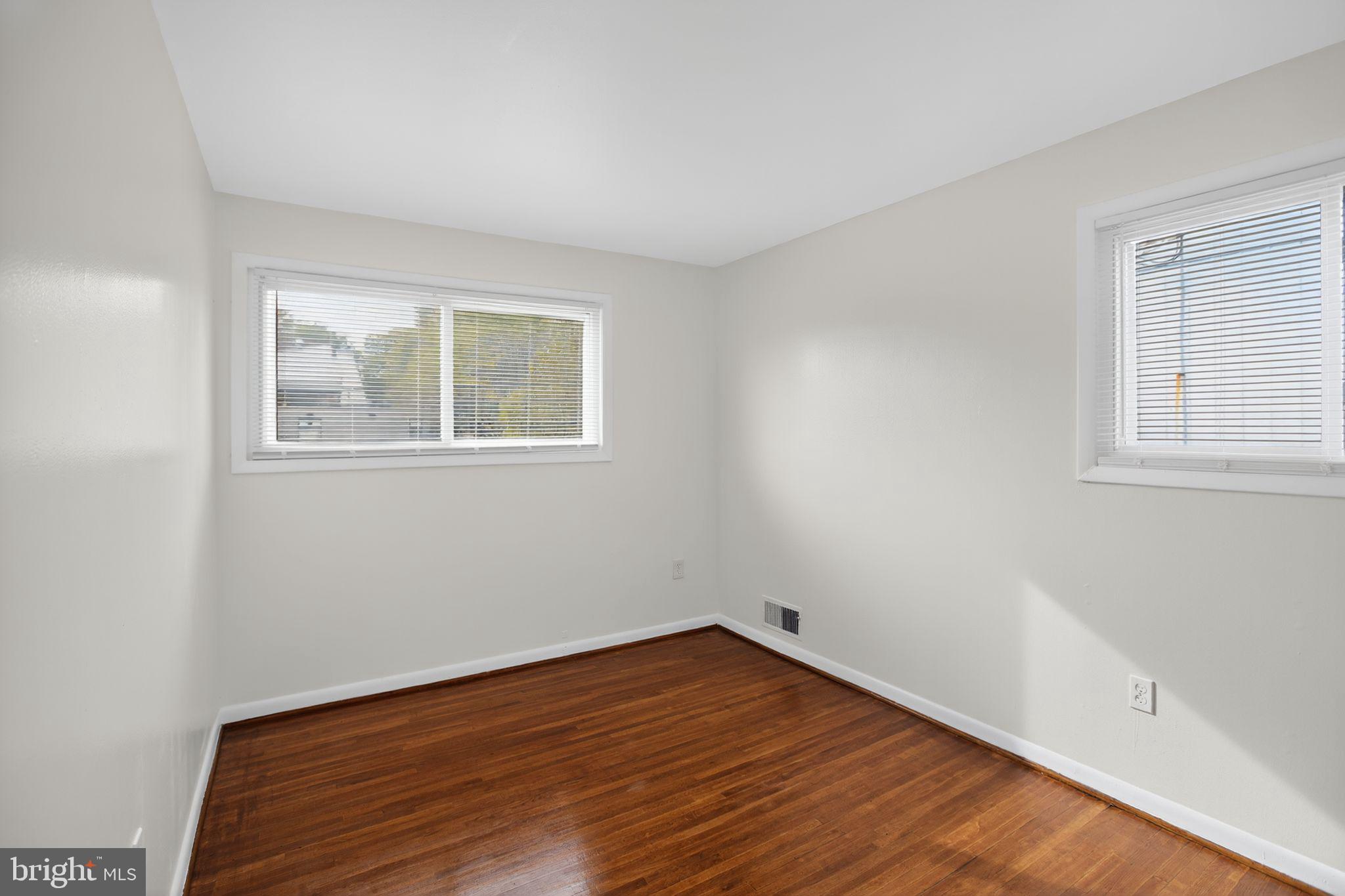 1432 41st Street Southeast Washington, DC 20020 - Photo 7 of 29 a view of an empty room with wooden floor and a window