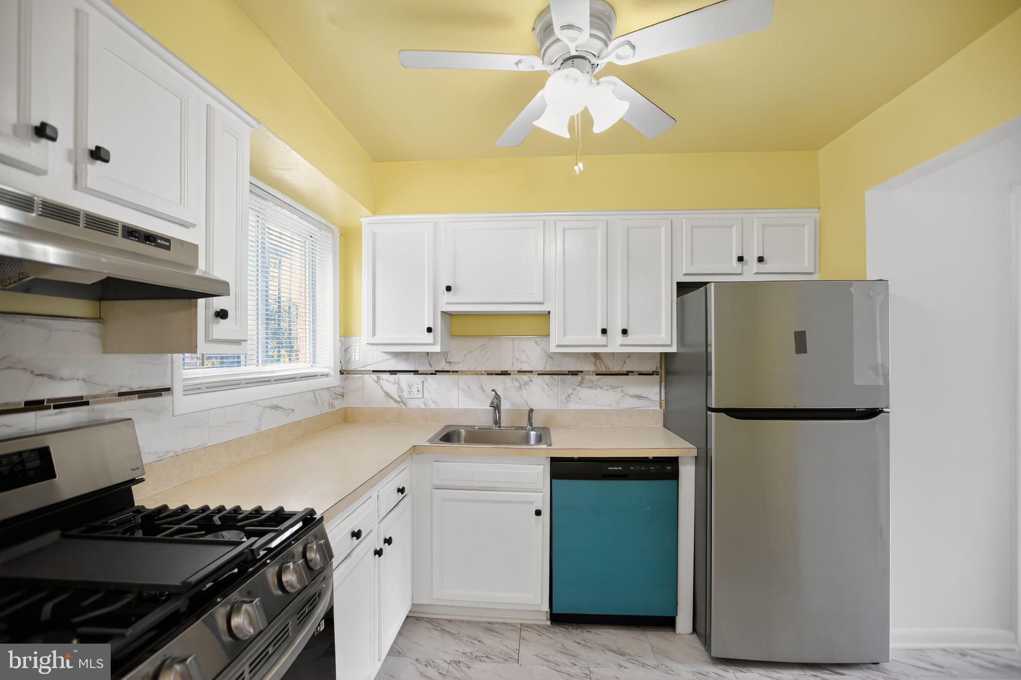 1432 41st Street Southeast Washington, DC 20020 - Photo 8 of 29 a kitchen with a sink stove and refrigerator