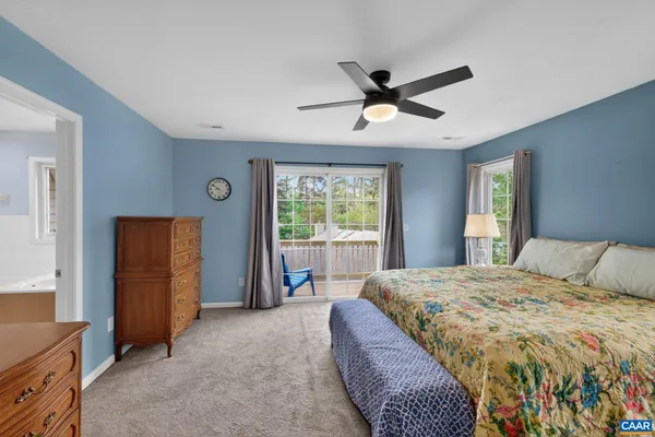 a spacious bedroom with a bed and a window