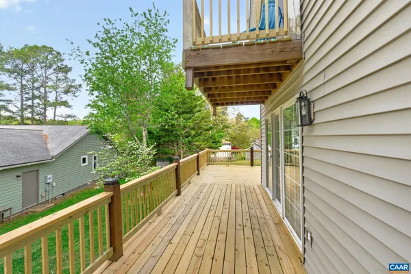 a view of balcony with wooden floor and fence and floor