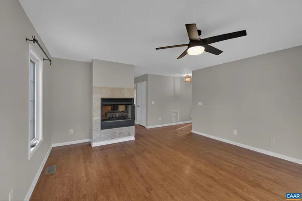 wooden floor in an empty room with a window
