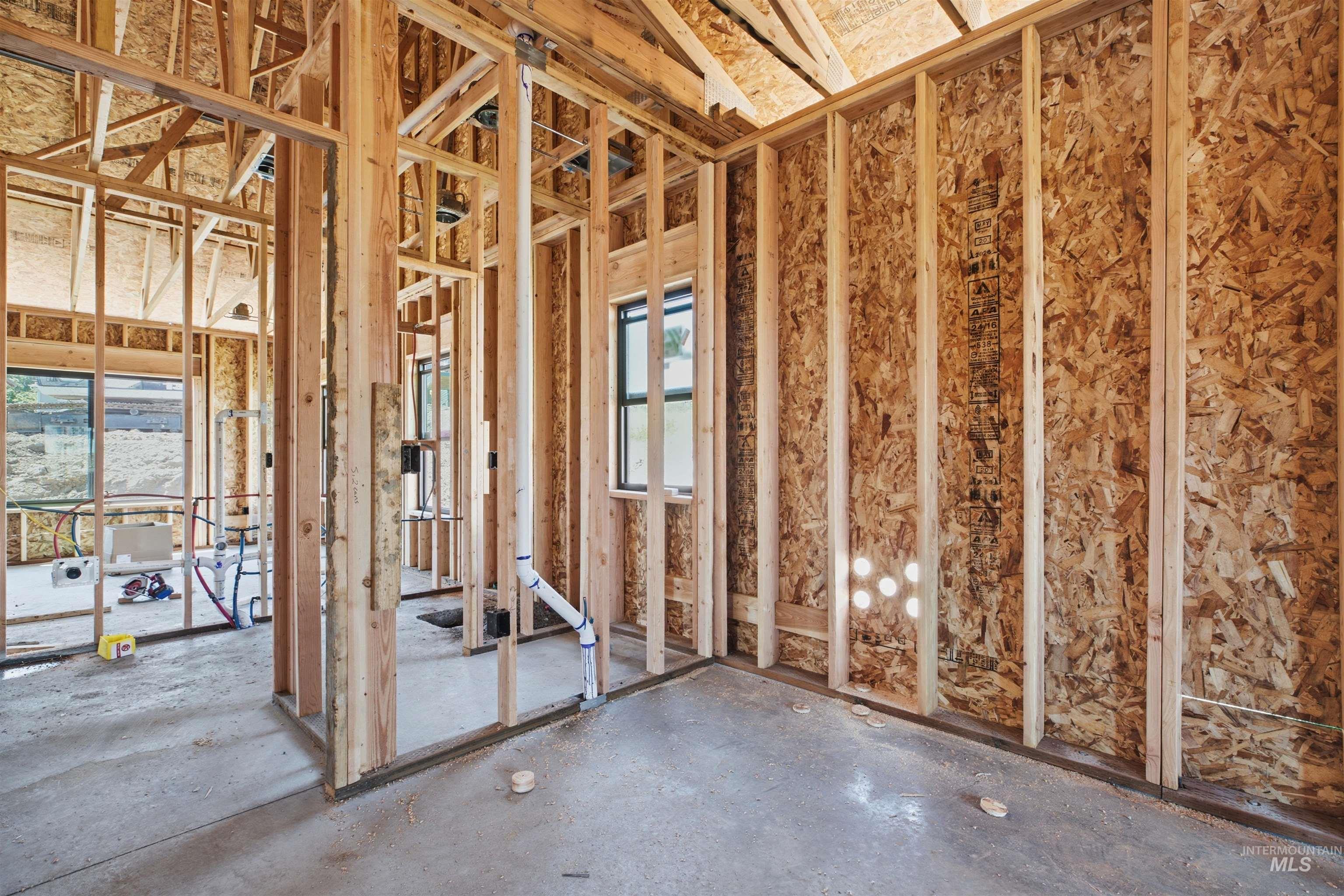 2824 Cyprus Court Moscow, ID 83843 - Photo 10 of 20 Interior framing featuring exposed wood studs, OSB sheathing, and concrete slab flooring
