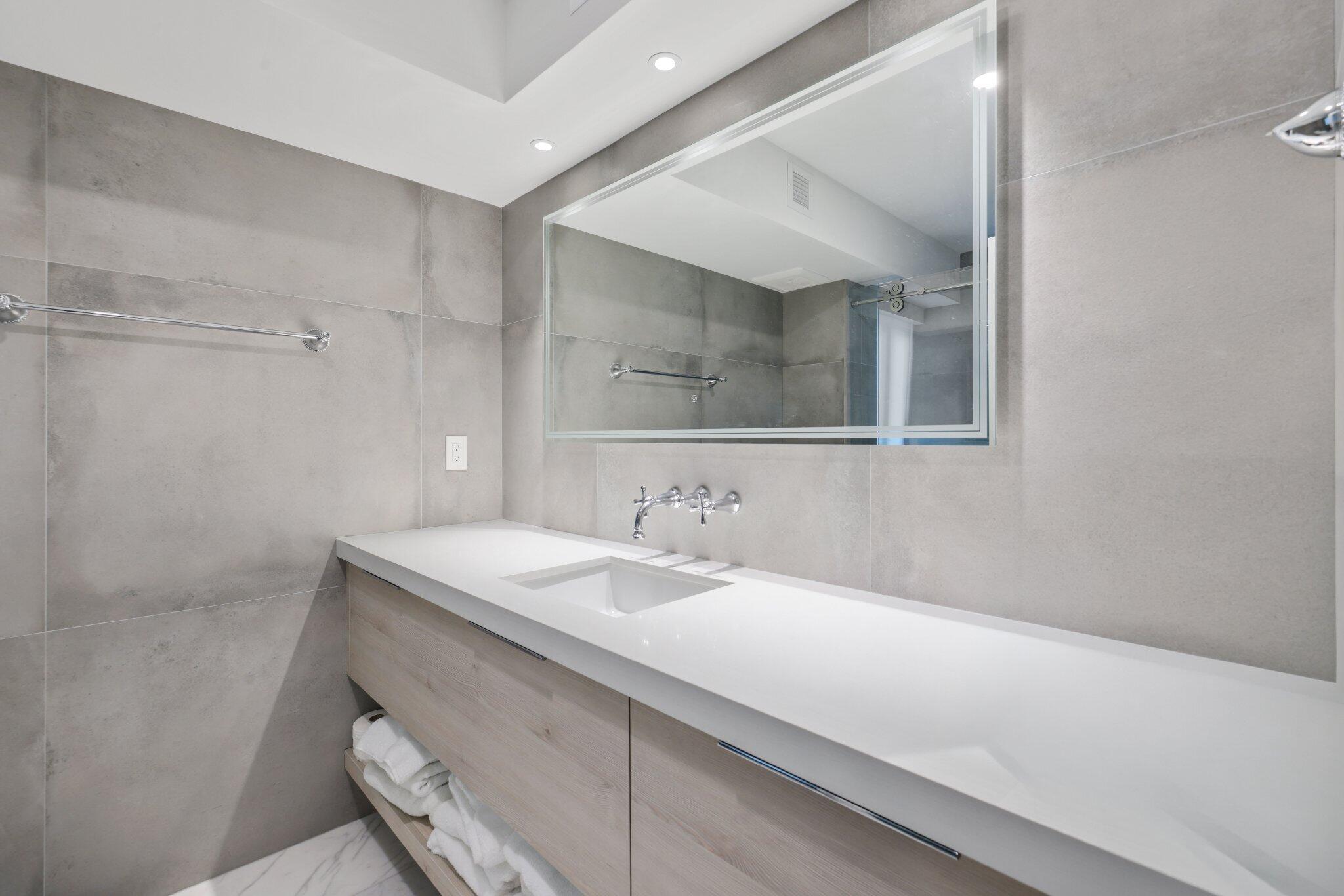 100 Southeast 5th Avenue, Unit 106 Boca Raton, FL 33432 - Photo 28 of 81 a bathroom with a sink a vanity and a mirror