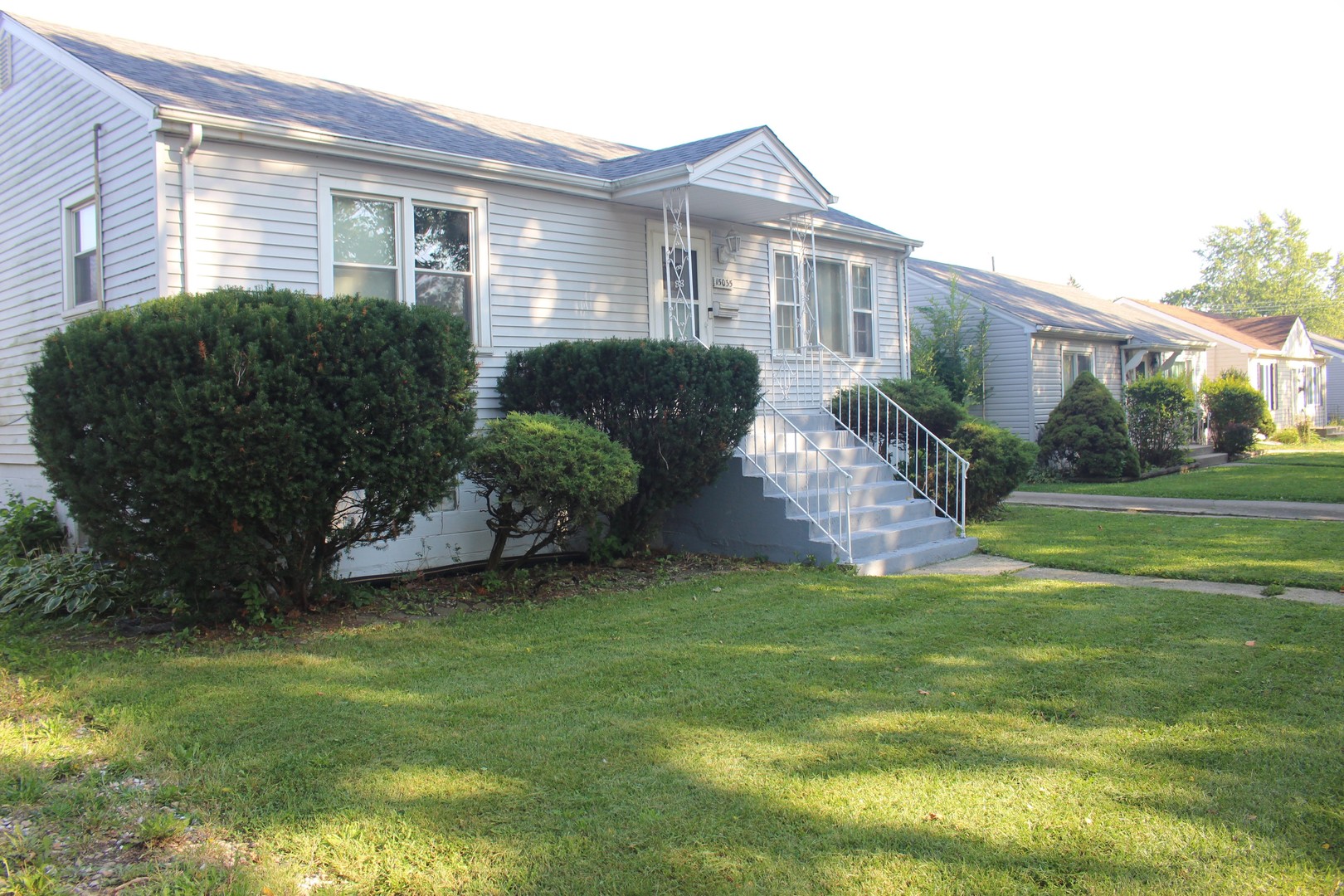 15035 Harding Avenue Midlothian, IL 60445 - Photo 2 of 32 a front view of a house with a garden