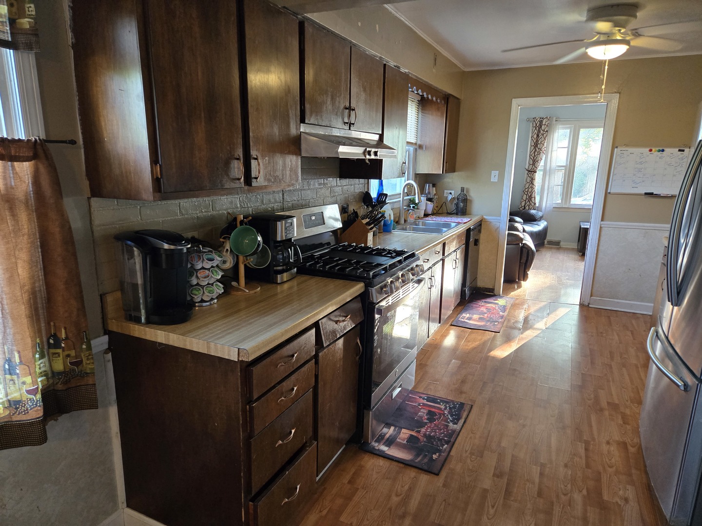 15035 Harding Avenue Midlothian, IL 60445 - Photo 10 of 32 a kitchen with stainless steel appliances granite countertop a stove a sink dishwasher and a refrigerator with wooden floor