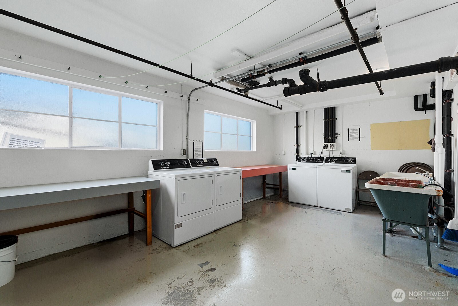 4407 Southwest Alaska Street, Unit 11 Seattle, WA 98116 - Photo 13 of 24 a utility room with cabinets dryer and washer