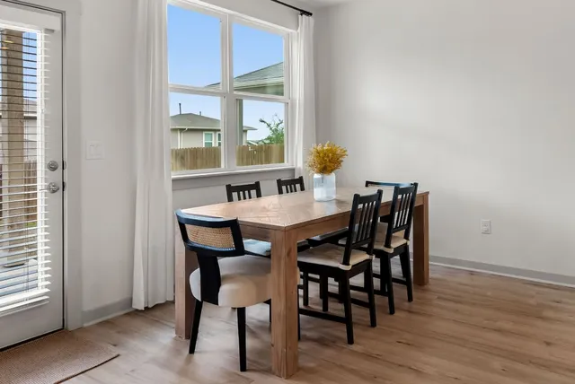 a kitchen with a refrigerator a microwave a stove top oven and cabinets
