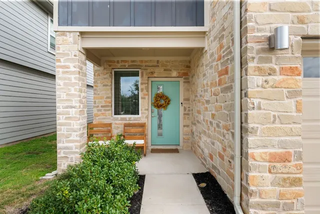 a view of a brick house with a large windows