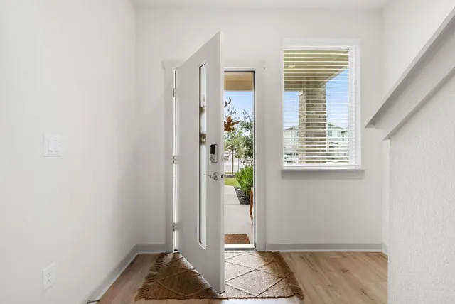 a view of entryway with wooden floor and windows