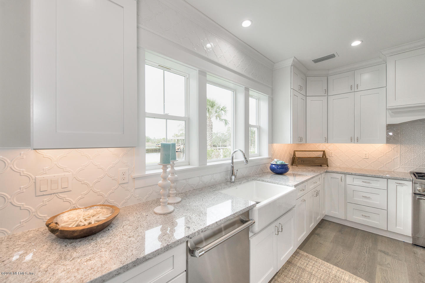 14712 Stacey Road Jacksonville, FL 32250 - Photo 17 of 26 a kitchen with stainless steel appliances granite countertop a sink and a white cabinets