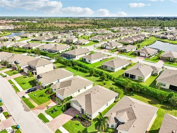 an aerial view of residential houses with outdoor space and street view