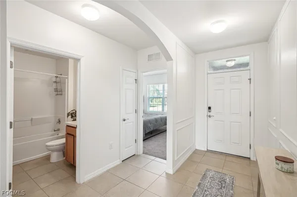 a bathroom with a granite countertop sink mirror and toilet