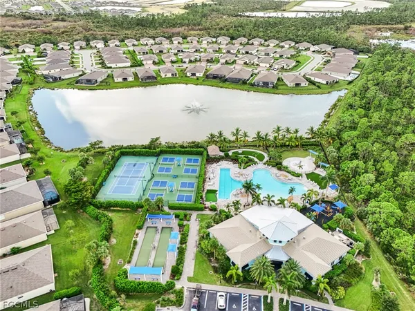 an aerial view of a house with a yard basket ball court