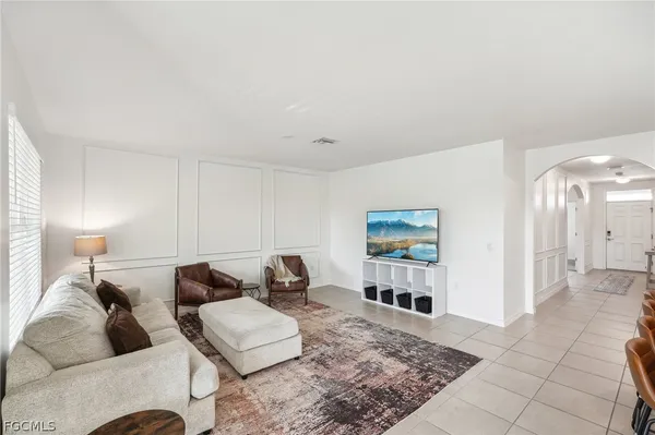 a living room with furniture and a rug