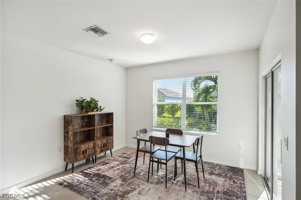 a dining room with furniture and wooden floor