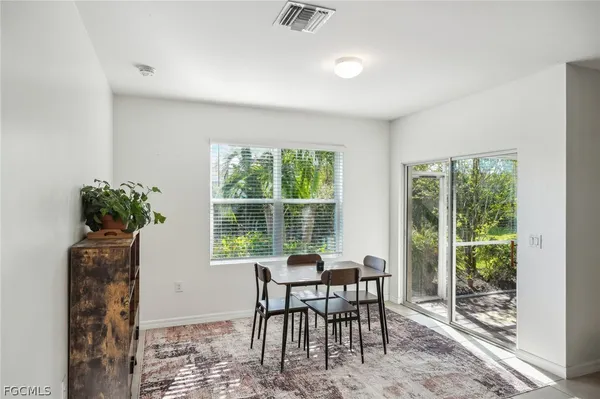 a dining room with furniture and window