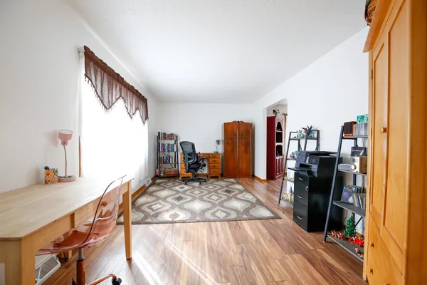 a bedroom with furniture and a window