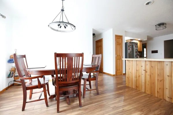 a bed sitting in a bedroom next to a window with a baby bed a couch and a bookshelf