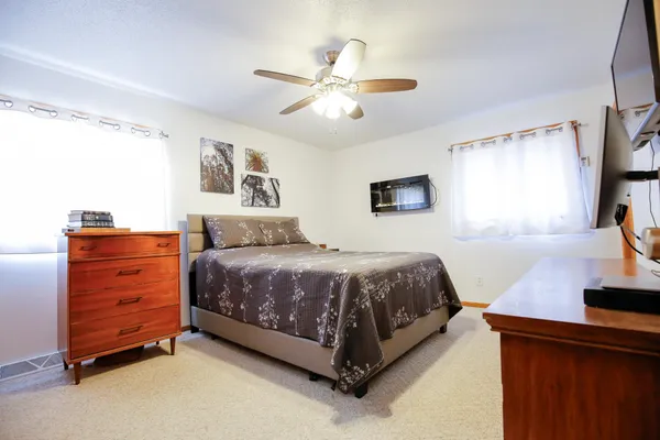 a bedroom with a large bed and a chandelier