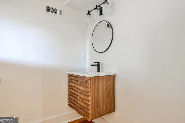 a bathroom with a sink and a mirror