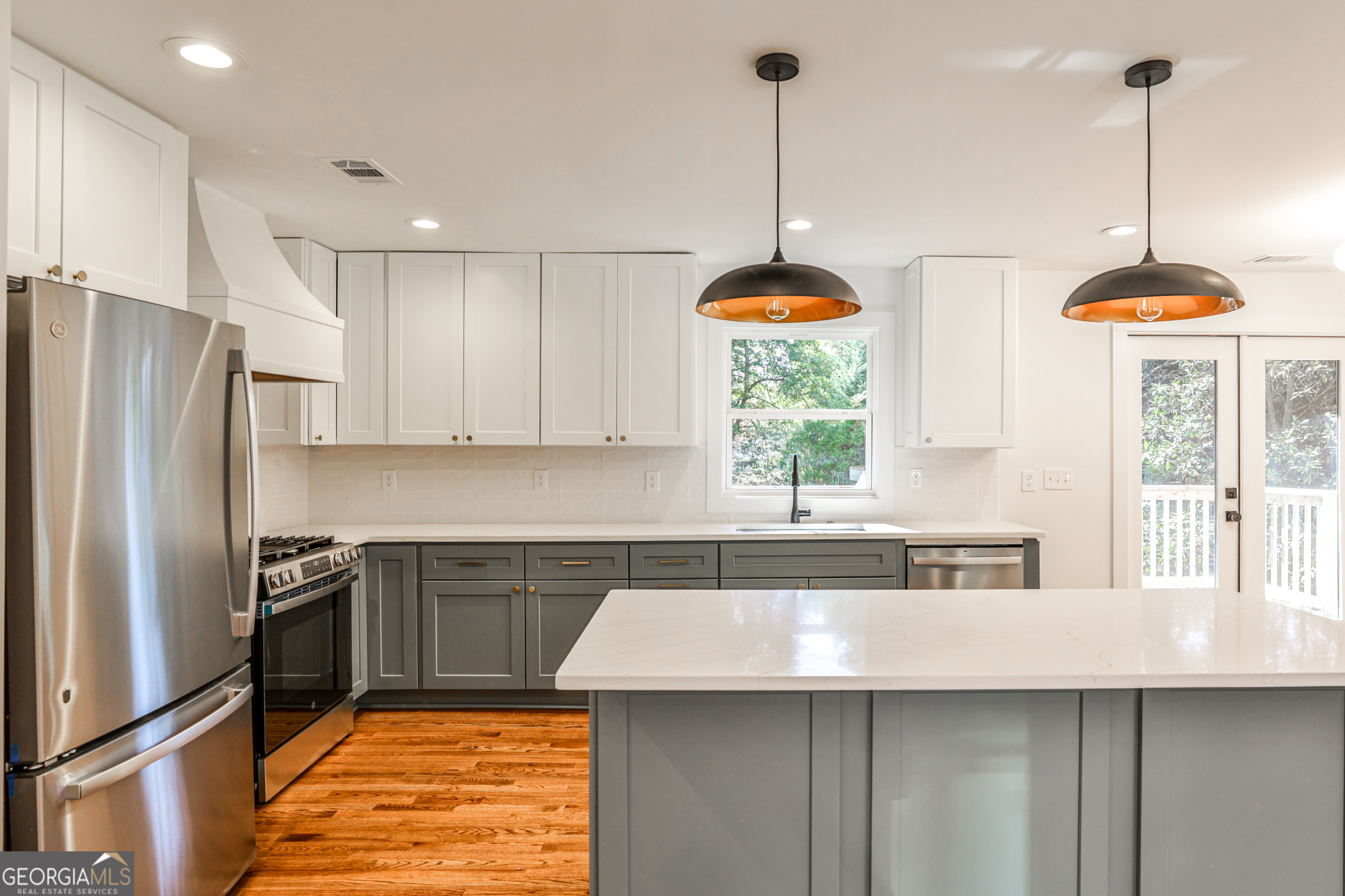 3029 Charlbury Place Avondale Estates, GA 30002 - Photo 2 of 27 a kitchen with stainless steel appliances granite countertop a sink a refrigerator and a wooden floor