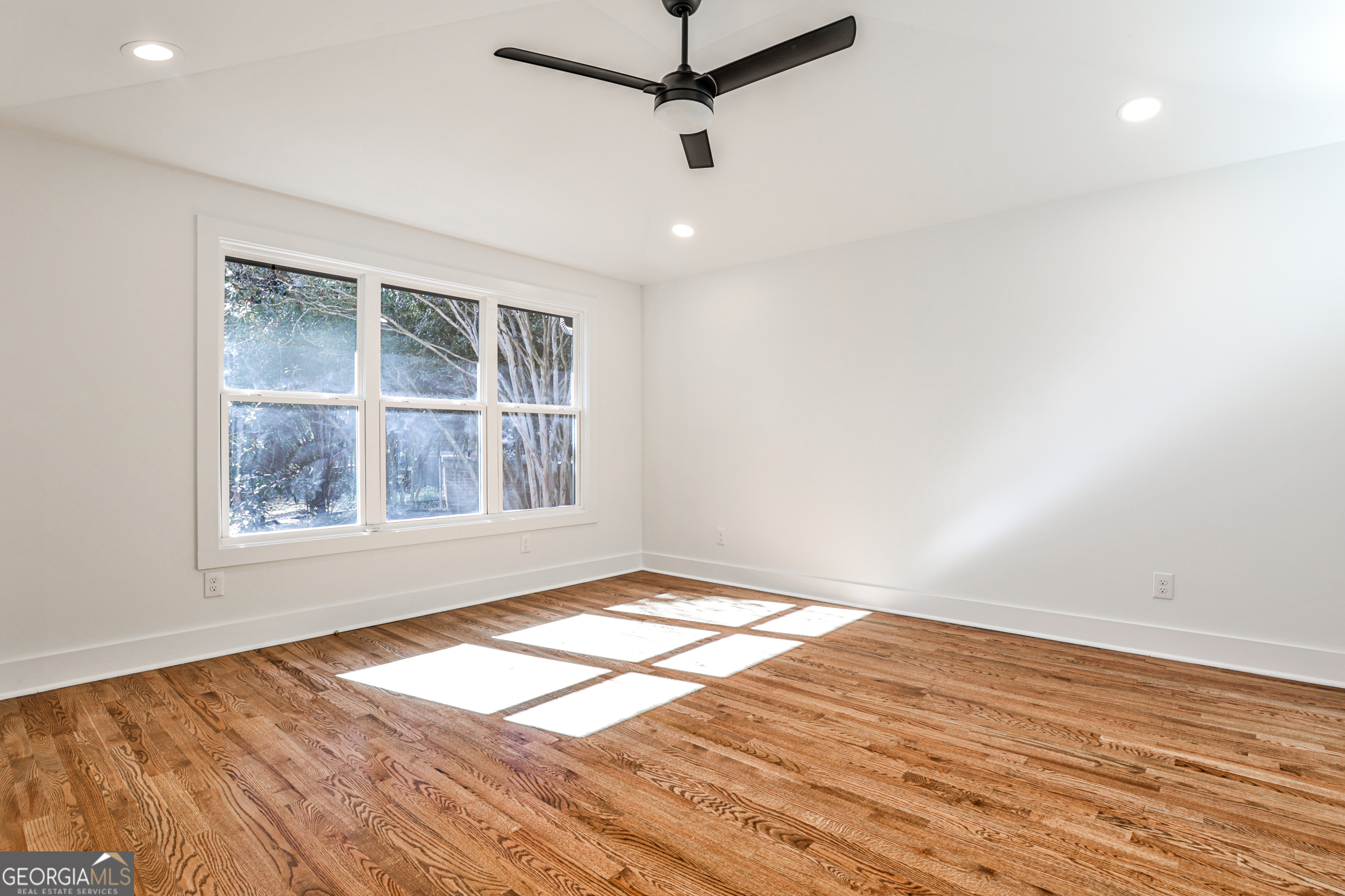 3029 Charlbury Place Avondale Estates, GA 30002 - Photo 24 of 27 an empty room with wooden floor cabinet and windows