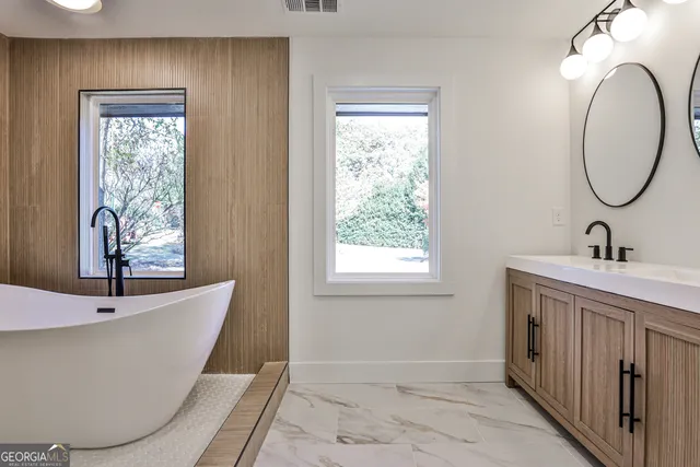 a bathroom with a bathtub and a window