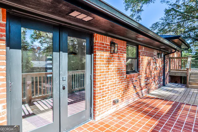 a view of a porch with a table and chairs