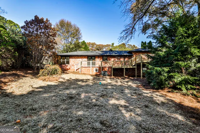 a front view of a house with a tree