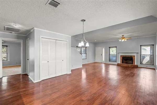 a dining room with furniture a window and wooden floor