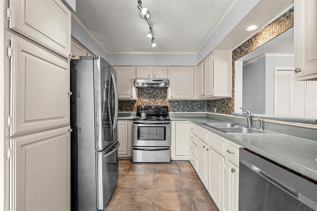 156 Pleasant Grove Lane, Unit 5 Waco, TX 76712 - Photo 13 of 37 a kitchen with a sink stove and refrigerator