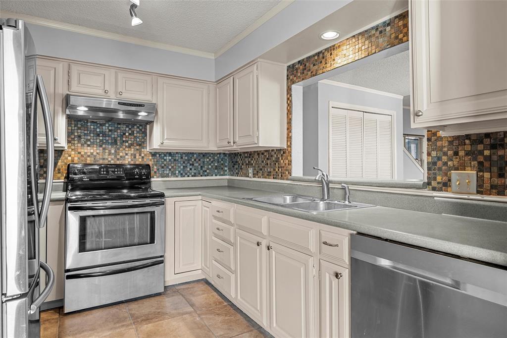 156 Pleasant Grove Lane, Unit 5 Waco, TX 76712 - Photo 14 of 37 a kitchen with granite countertop white cabinets and appliances