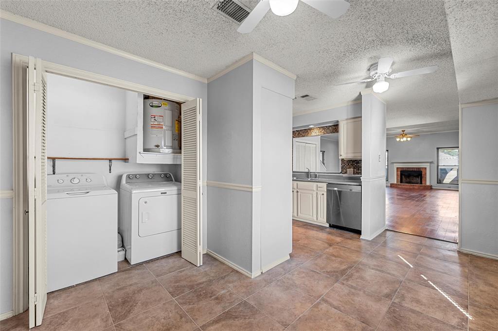 156 Pleasant Grove Lane, Unit 5 Waco, TX 76712 - Photo 18 of 37 a view of a kitchen with refrigerator and white cabinets