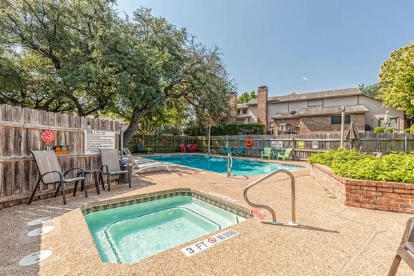 swimming pool view with a seating space and a garden view