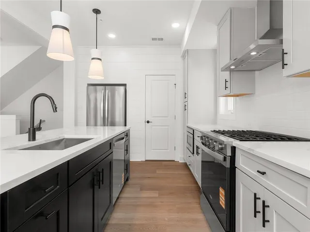 a kitchen with a sink stove and refrigerator