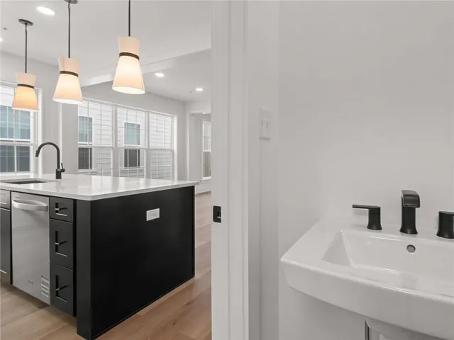 a kitchen with a sink cabinets and window