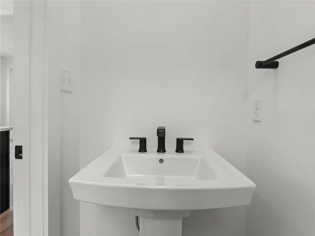 a white sink sitting under a bathroom