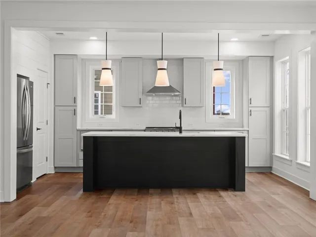a view of kitchen with wooden floor and a window