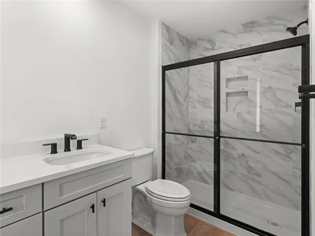 a bathroom with a sink toilet and shower