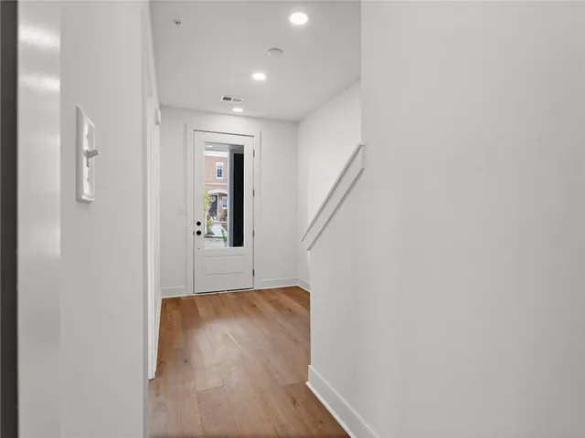 a view of hallway with wooden floor