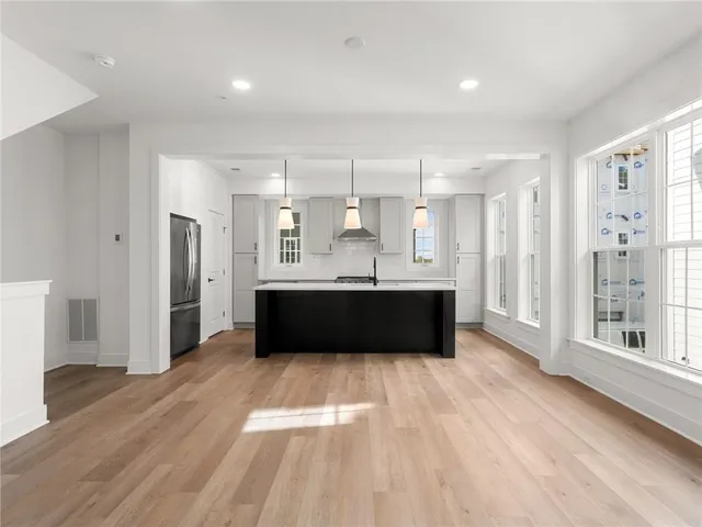 a large white kitchen with a large window