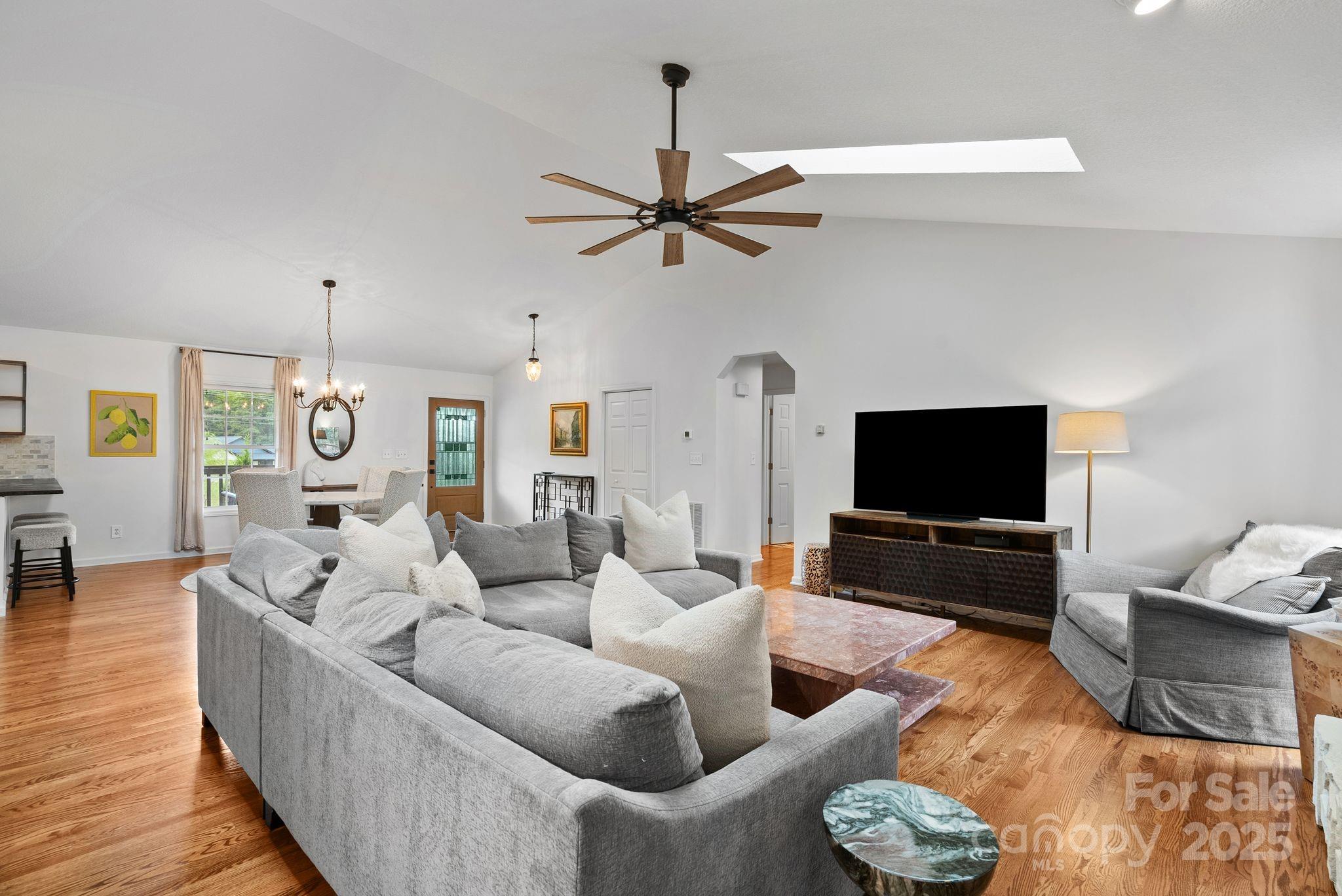 6 Sayles Town Road Fairview, NC 28730 - Photo 13 of 43 a living room with furniture a ceiling fan and a flat screen tv