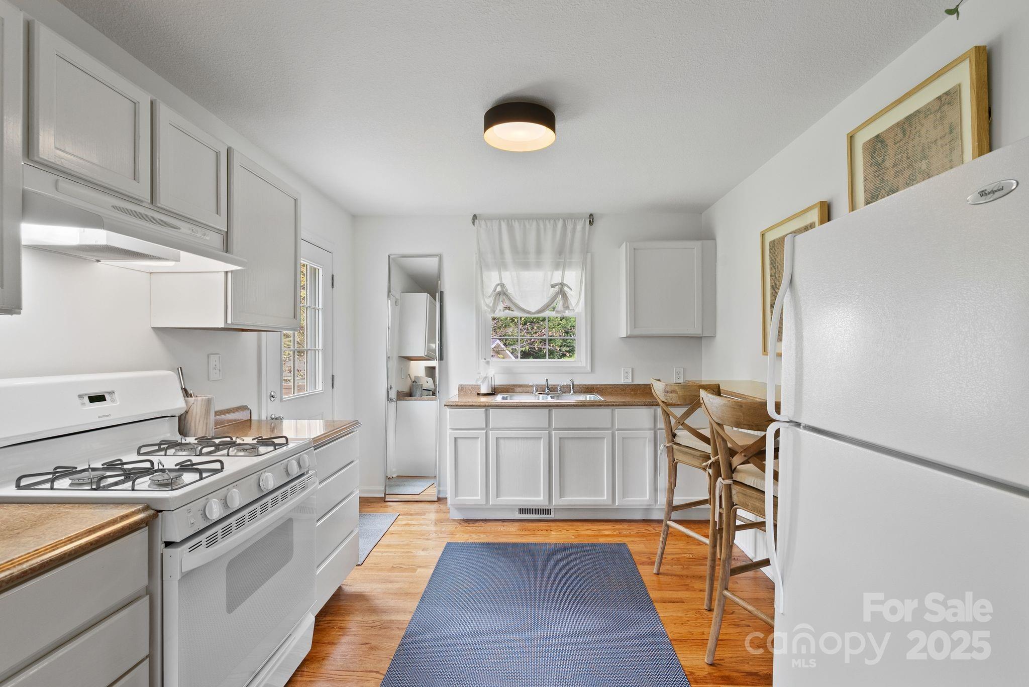 6 Sayles Town Road Fairview, NC 28730 - Photo 31 of 43 a kitchen with stainless steel appliances granite countertop a stove a sink and a refrigerator