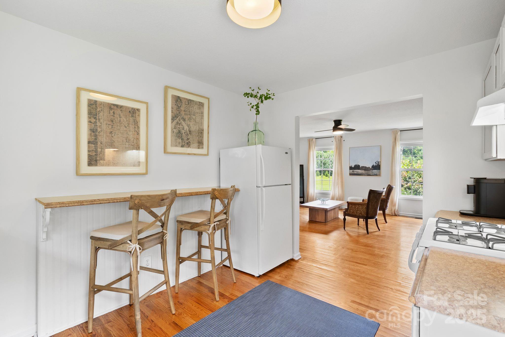 6 Sayles Town Road Fairview, NC 28730 - Photo 32 of 43 a living room with furniture and a dining table with wooden floor